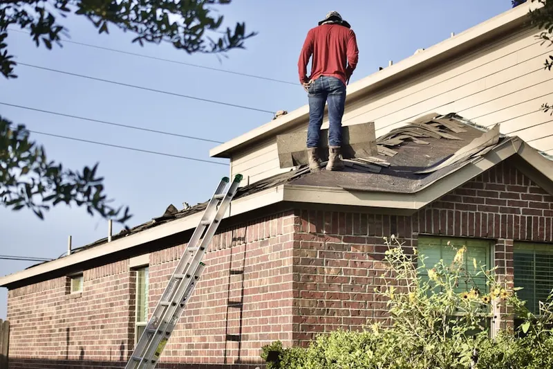 Professional roofer working on a residential roof in Arborwalk
